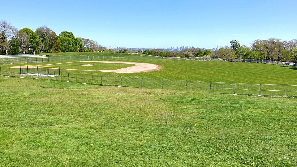 Robbins Farm Park in Arlington, MA, with the Boston skyline beyond — about 11 minutes from Robert's Salon and Spa