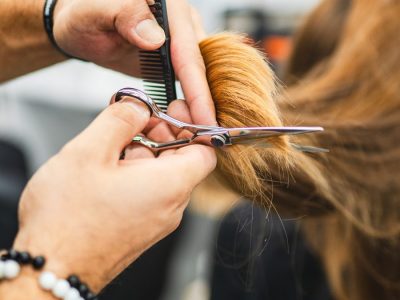 Stylist cutting long hair at Robert's Salon and Spa in Belmont, MA